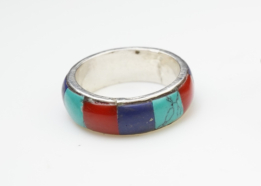 A collection of silver jewellery including a Zuni bangle